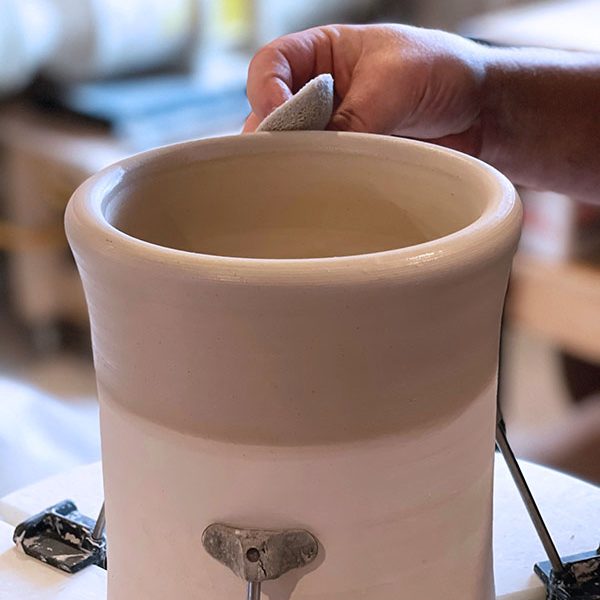 6 These serving bowls are trimmed on a chuck after the rims are altered and handles are attached. Either use a leather-hard chuck or dampen a bone-dry chuck so it sticks to the bowl while trimming to keep it in place.