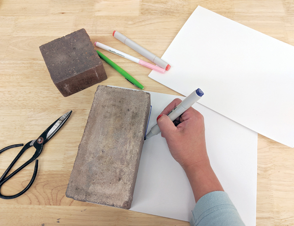 1 Lay your brick on the paper backing of the craft foam and trace it.