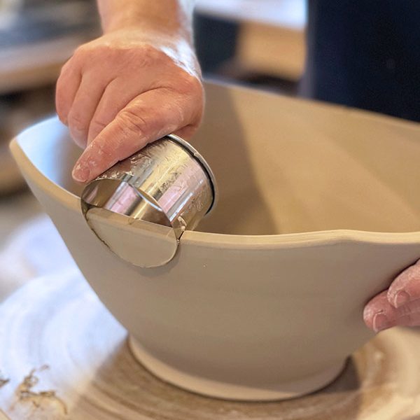 1 Use a ruler to mark the middle of the sides of the bowl and use a circle cutter to cut a half circle in the rim where the handles will be added.