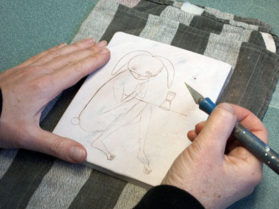 Draw/carve into the clay with a sharp Exacto knife to create the lines.