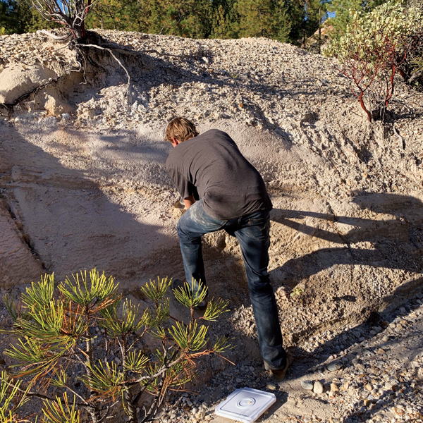 B Matt Fishman examining the materials at various levels of an outcropping. Photo: Kate Gibbs.