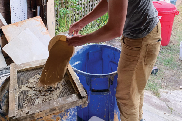 H Screen the wild clay slip through a relatively large mesh to filter out twigs, leaves, and large stones, while leaving as much texture as possible. Photo: Kate Gibbs. 