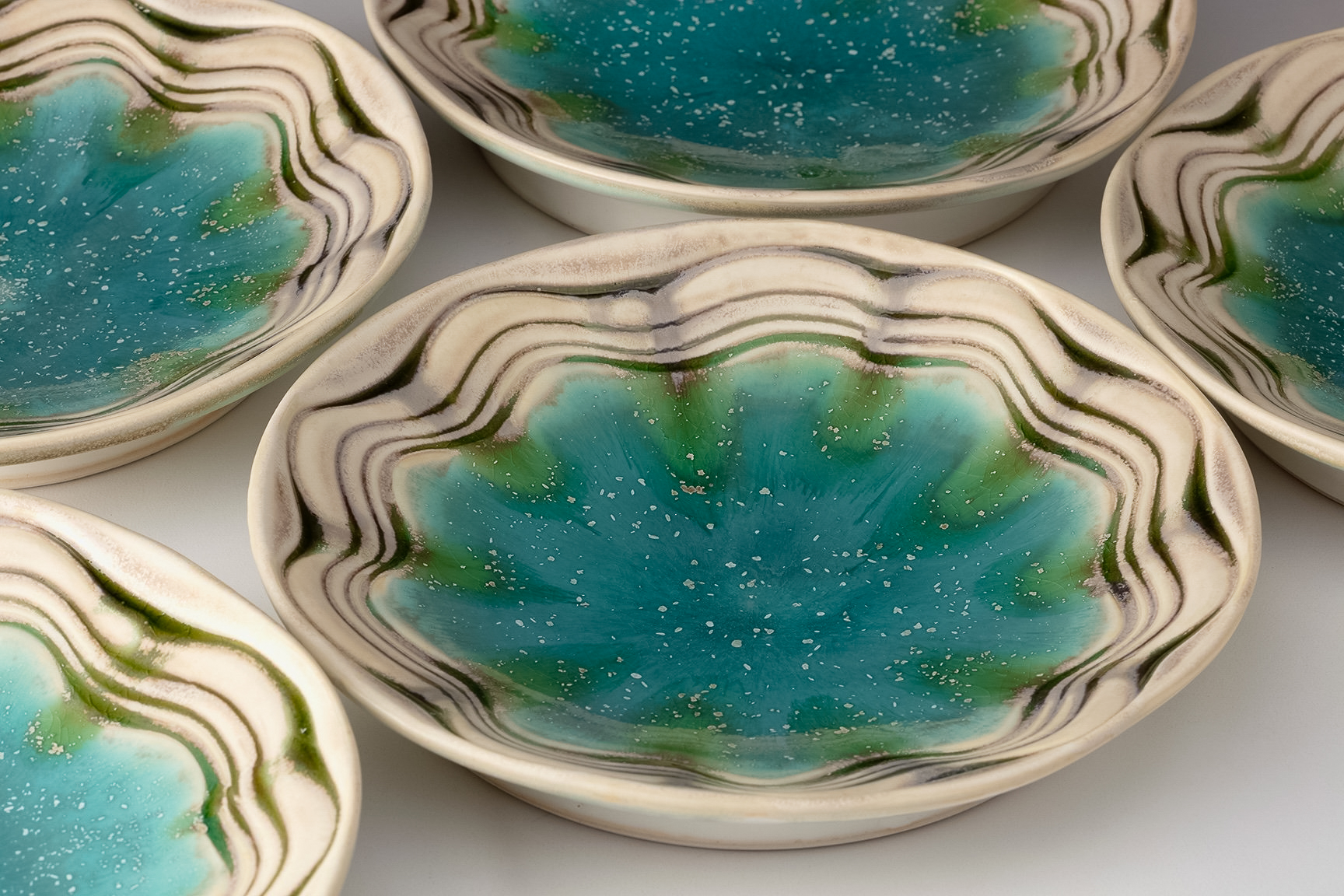 Ceramic bowls with a blue-green glaze by Aysha Peltz