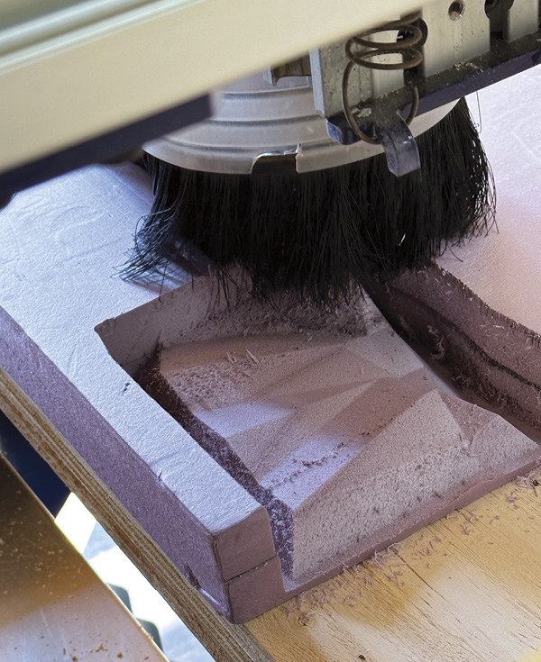 1 A CNC milling machine cutting a block of foam.