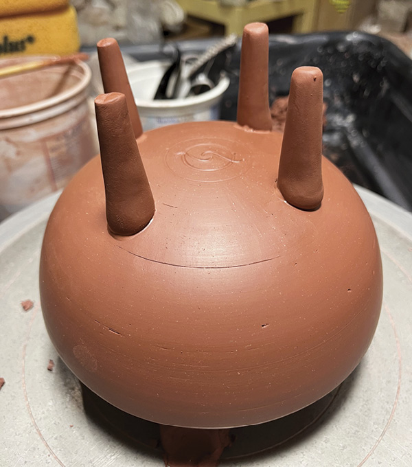 6 Attach 3–4 legs to the bottom of the teapot when the piece is leather hard. Make and attach a spout and handle.