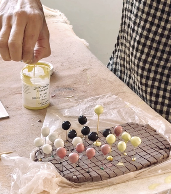 5 Form lots of small balls. Use a toothpick to dip the balls into underglaze and let them dry on a slab of clay.