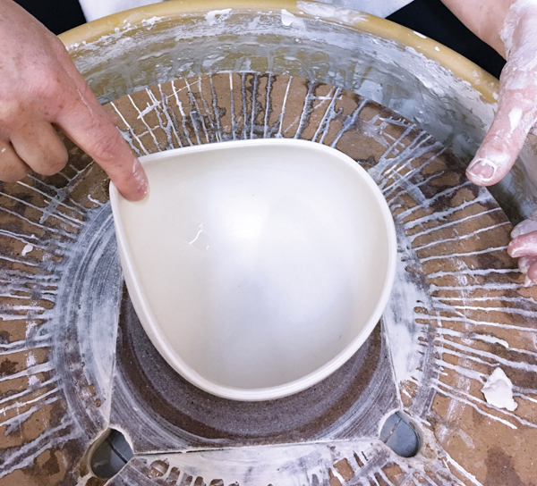 6 While the bowl is still wet, use your finger to pull and alter the bowl’s rim.