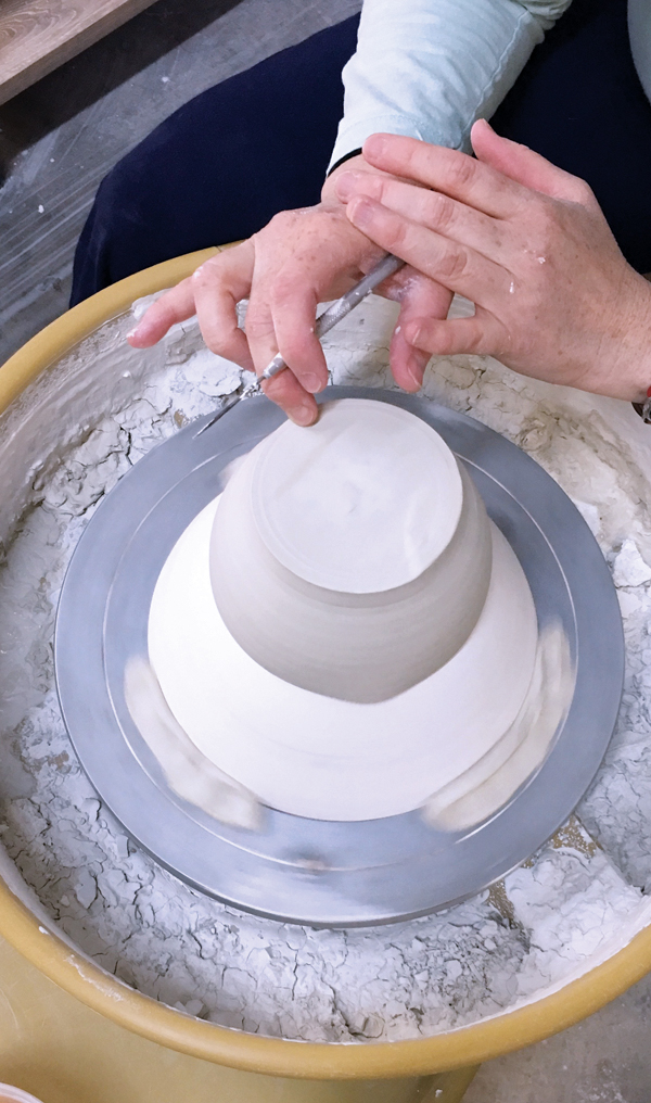 7 Center the bowl on a chuck that is attached to the wheel head. The chuck is important to maintain the altered rim.