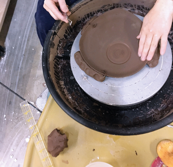 10 Anchor the leather-hard saucer to the wheel head and trim an indent for the bowl. I trim my indents off center.