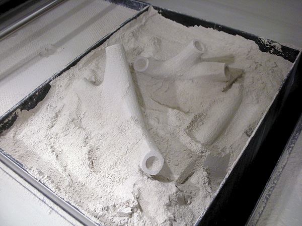 2 3D printed components being extracted from the print bed for Ground Substance, a research prototype by Sabin+Jones LabStudio, 2009. Photo: Jenny Sabin.