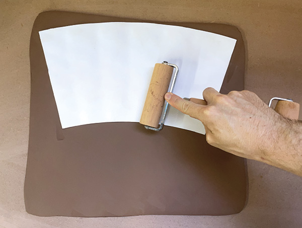 3 Place the template on a slab of clay texture-side down and apply even pressure.