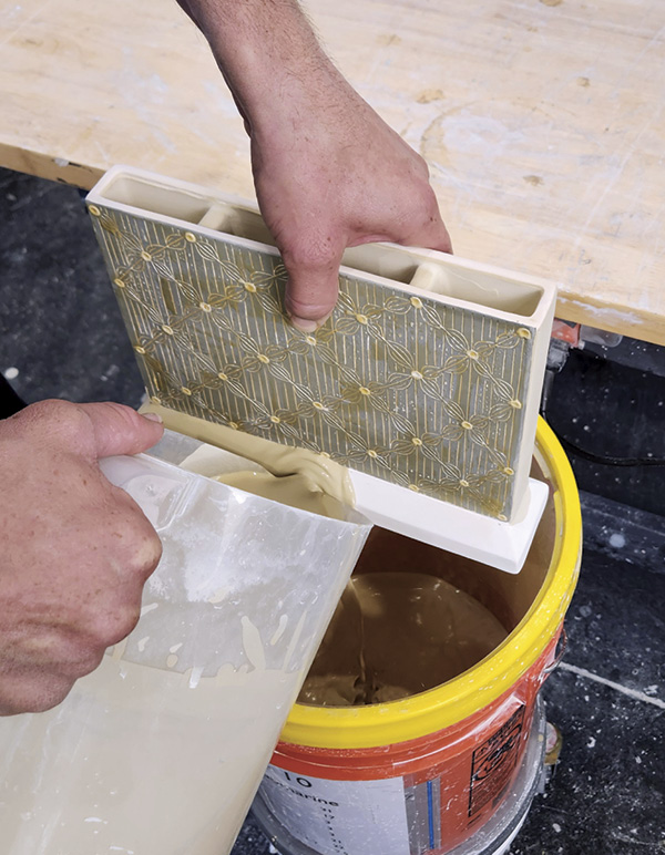 15 Pour glaze around the base of the vase and sponge glaze off waxed areas.