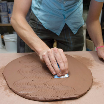 Fig.1 Use the cut edge of a plastic card to create texture on the top of the flower brick.