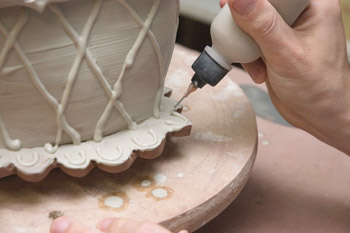 Fig.11 Slip trail patterns onto the bottom scalloped skirt of the flower brick.