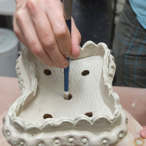 Fig.14 Round out and smooth the edge of the holes with a paintbrush handle.