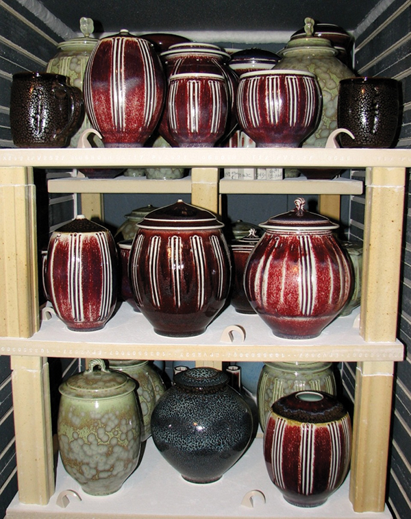 This image shows one of Tom Turner’s perfectly even glaze firings from his 12-cubic-foot front-loading electric kiln. Notice the cone placement and how there is no difference between any of the cones. Placing cones all around the firing chamber like this allows you to see if there are hot or cool spots in your kiln. These pieces are glazed with copper red oxblood, oilspot, and non-running zinc crystal glazes developed by Turner. 2012. Photo by Steve Mann