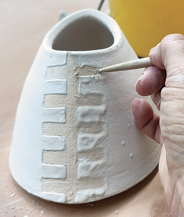 16 Glaze your piece by dipping, brushing, or spraying and clean the glazed edges of the pattern with a wooden tool.