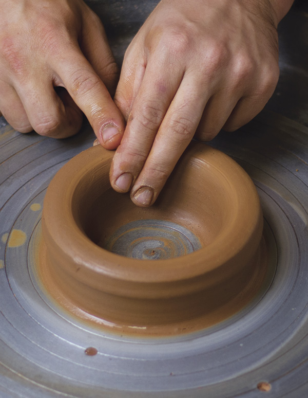 1 Open the centered clay into a bottomless cylinder about 5 in. (12.7 cm) wide.