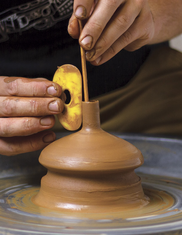 4 Use a wooden skewer to support the interior of the spout while throwing.