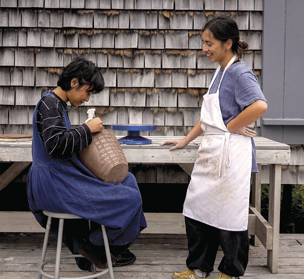 1 Participants in the 2023 Session 5 clay workshop Masibumbe (Soul Shaping into Clay) on the clay deck at Haystack Mountain School of Crafts, August 2023.