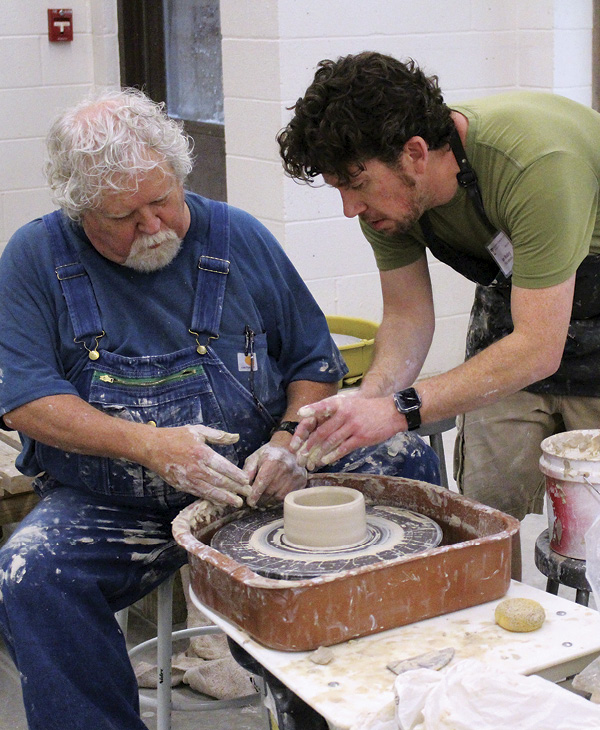 13 Ian Mabry, instructor and former resident, assisting a workshop participant.