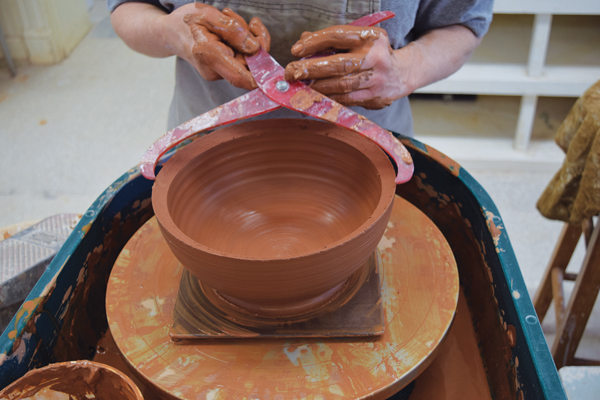 1 Throw a wide, sturdy bowl. Cut the rim at a downward angle toward the inside, and measure with calipers.