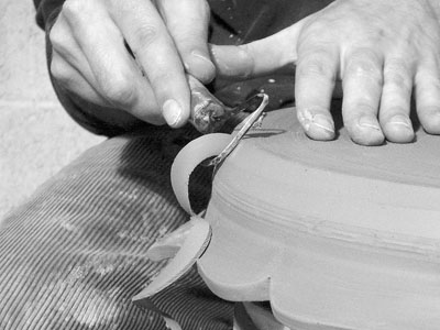 Attaching a donut-shaped chuck to your wheelhead before trimming takes the challenge out of trimming platters with delicate or altered rims.