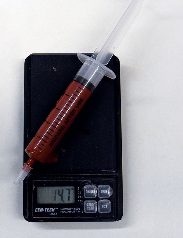 2 Weigh the syringe once it is filled with 10 mL of glaze. Move the decimal point of the resulting weight measurement one place to the left to find the specific gravity (1.47 in this example). 