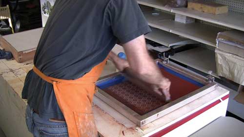 Screening slip ink onto the transfer newsprint.