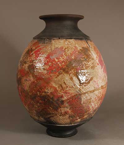 Raku fired pot with brushed stoneware glaze under clear raku glaze, by Steven Branfman.