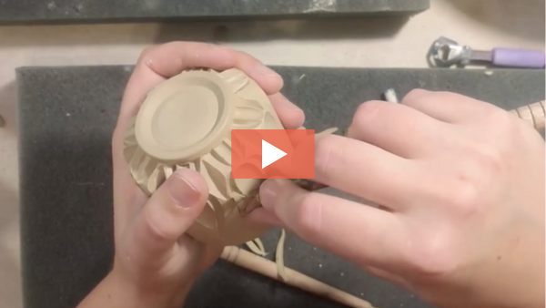 Image of Molly Walter carving a decorative surface into a small cup.